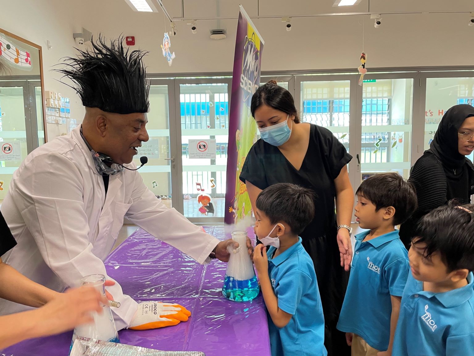 Children experiencing blowing carbon dioxide that was produced from dry ice in water.